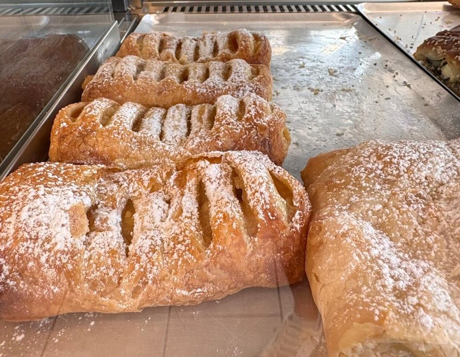 Sweet cream pastry rolls with powdered sugar, Bakery Kissamos